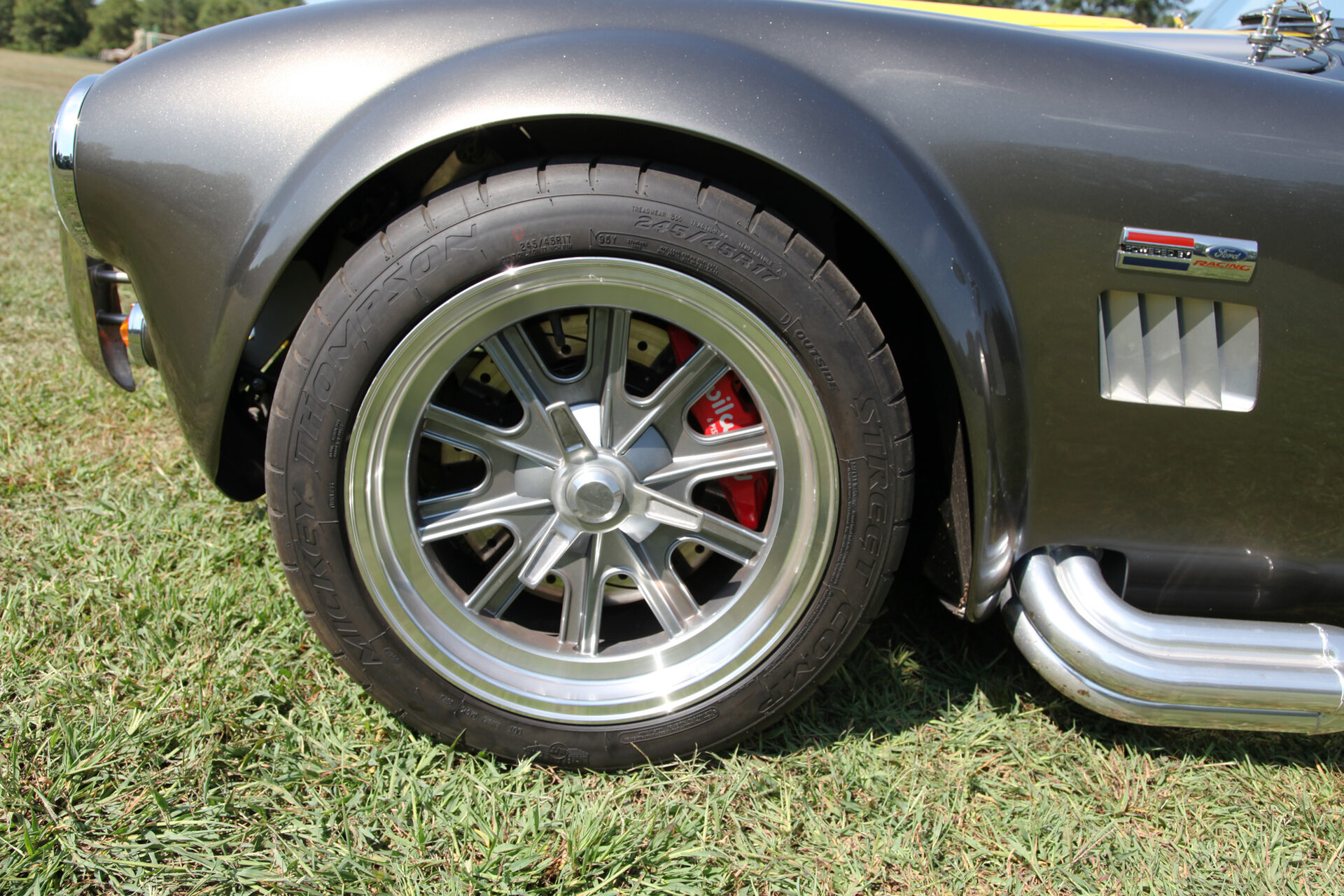 Close-up of Halibrand-style wheel and red Wilwood brake caliper